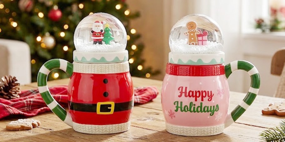santa and gingerbread man christmas mugs on table 