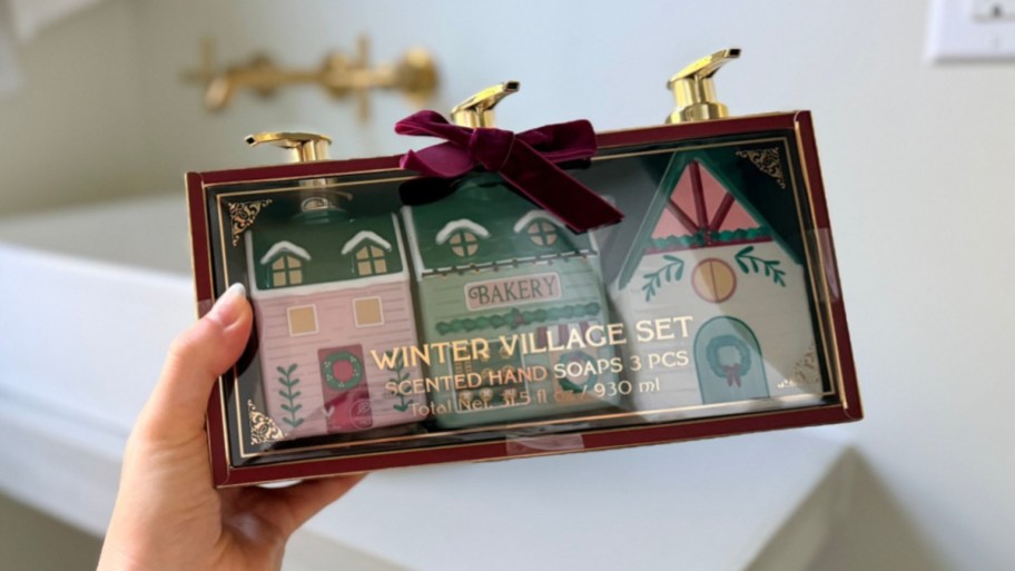 womans hand holding the package of christmas village hand soaps