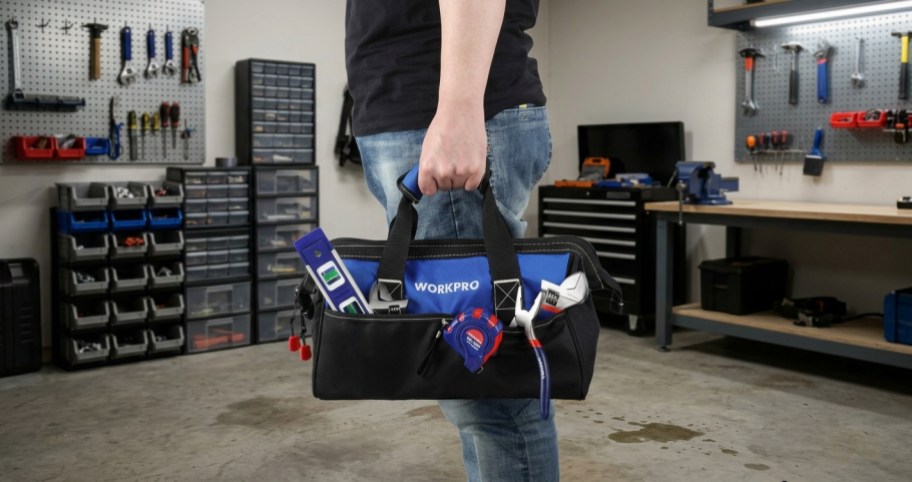 man standing in garage with tool set