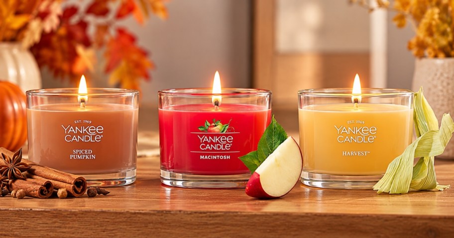 three mini glass votive Yankee candles with fall decor